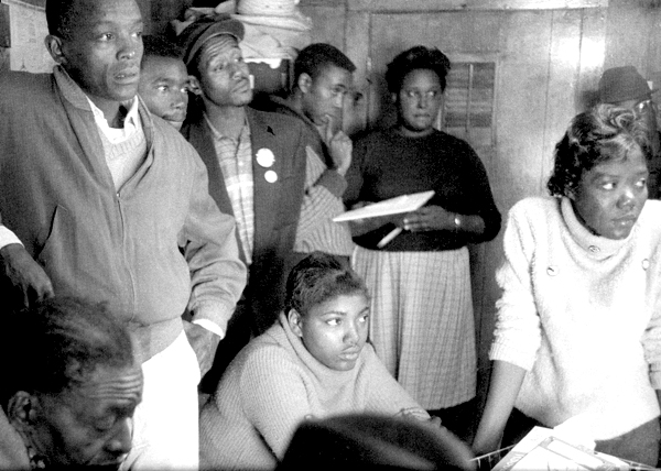 A photograph of SNCC workers being briefed before going in the Belzoni, MS, to oranize for the Freedom Vote, fall 1963. Ida Mae Holland is sitting in the center, crmvet.org