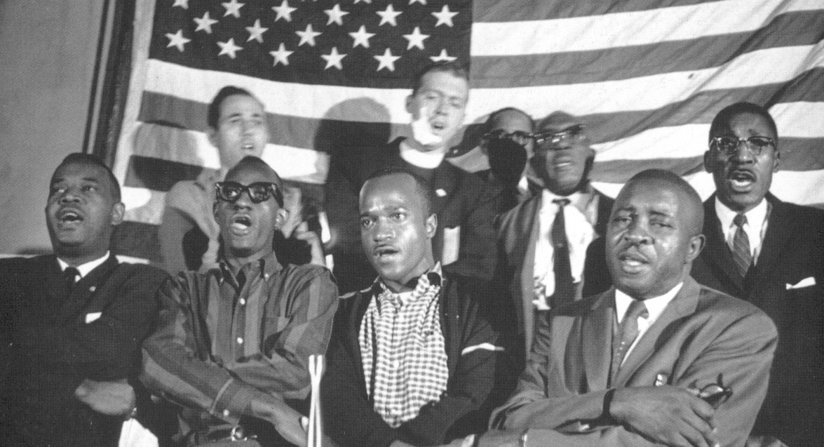 Rally for the Freedom Vote, Hinds County, Mississippi, 1963. Front row from left: NAACP leader Aaron Henry, SNCC organizers Sam Block and Willie Peacock, Matt Herron, crmvet.org